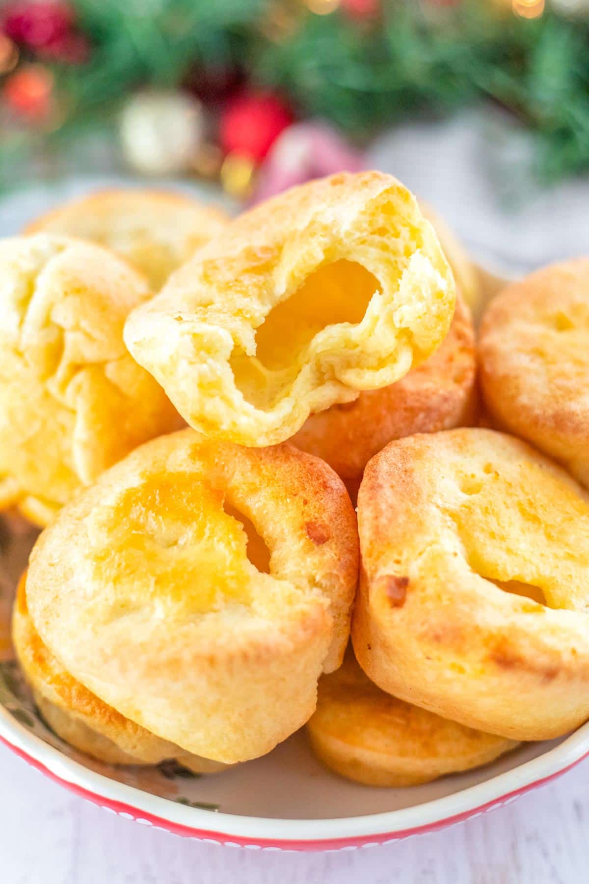 The finished Yorkshire Pudding on a serving plate piled on top of each other. 