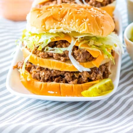 A finished Big Mac Sloppy Joe on a white plate.