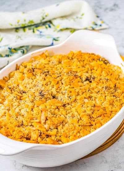 The finished Poppy Seed Chicken Casserole in a white casserole dish.