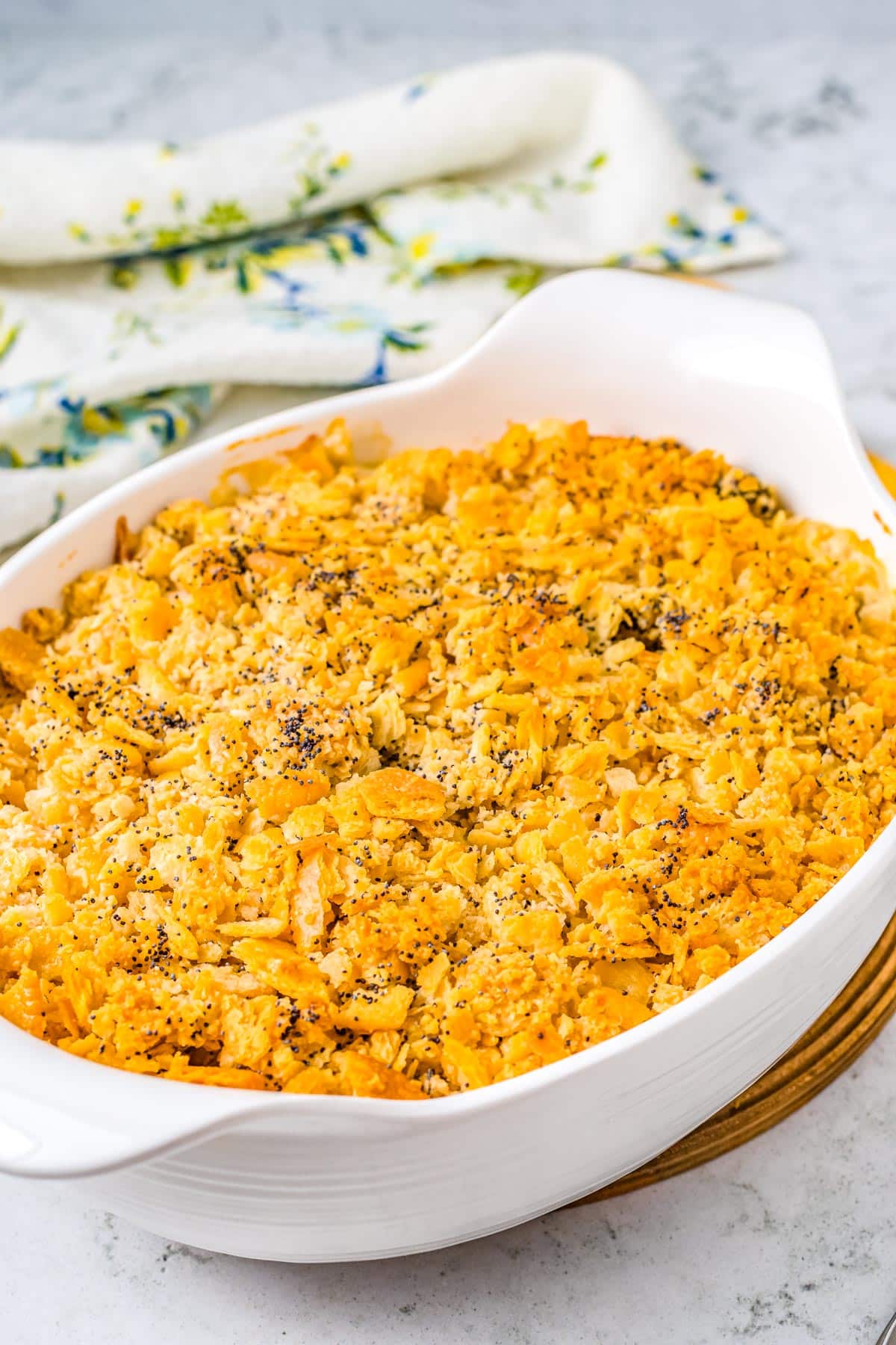 The finished Poppy Seed Chicken Casserole in a white casserole dish.