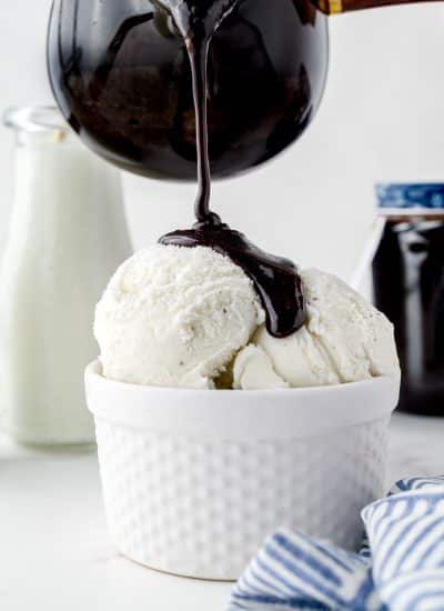 Homemade Chocolate Syrup being poured over ice cream.