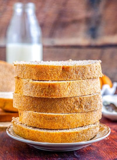 Slices of the finished recipe for Honey Whole Wheat Bread stacked on top of each other.