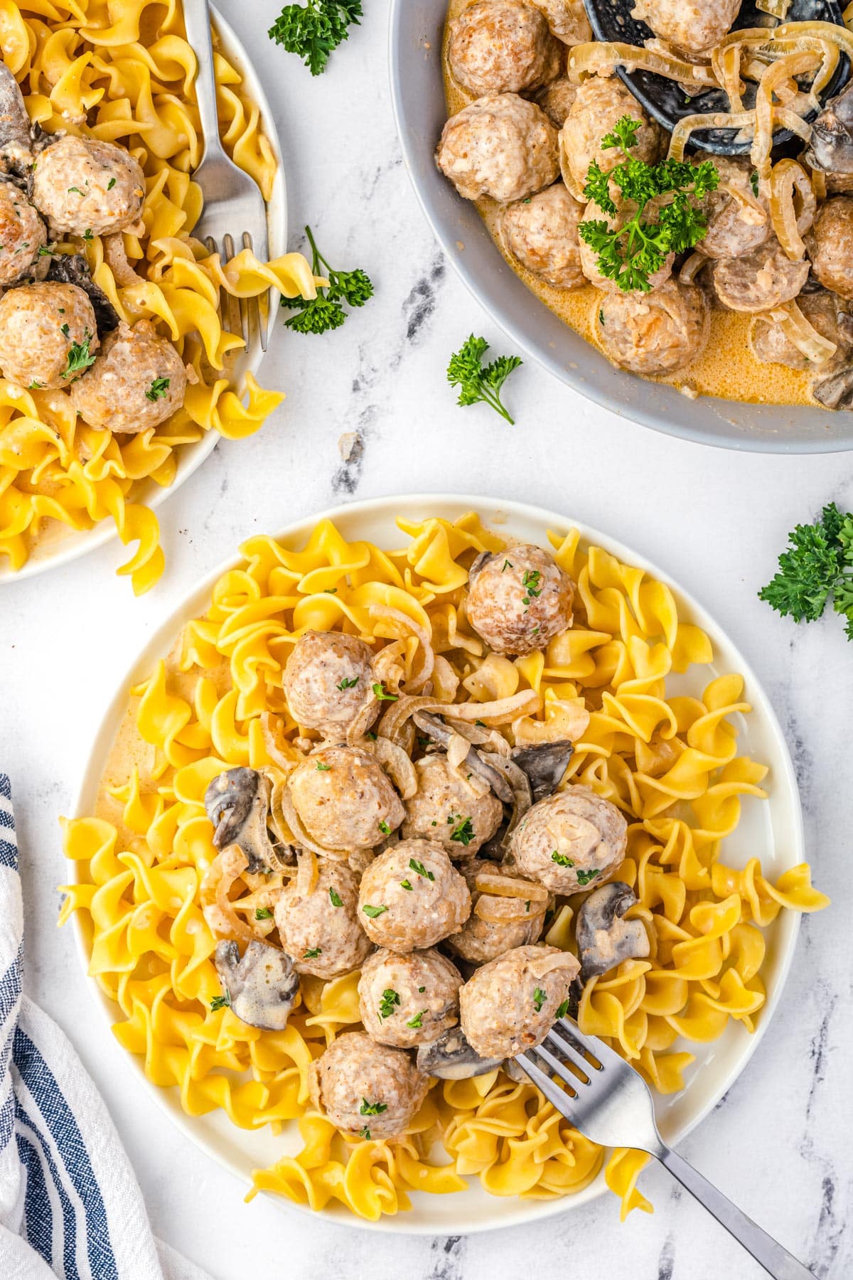 An overhead picture of the finished Stroganoff Meatballs served over buttered noodles.