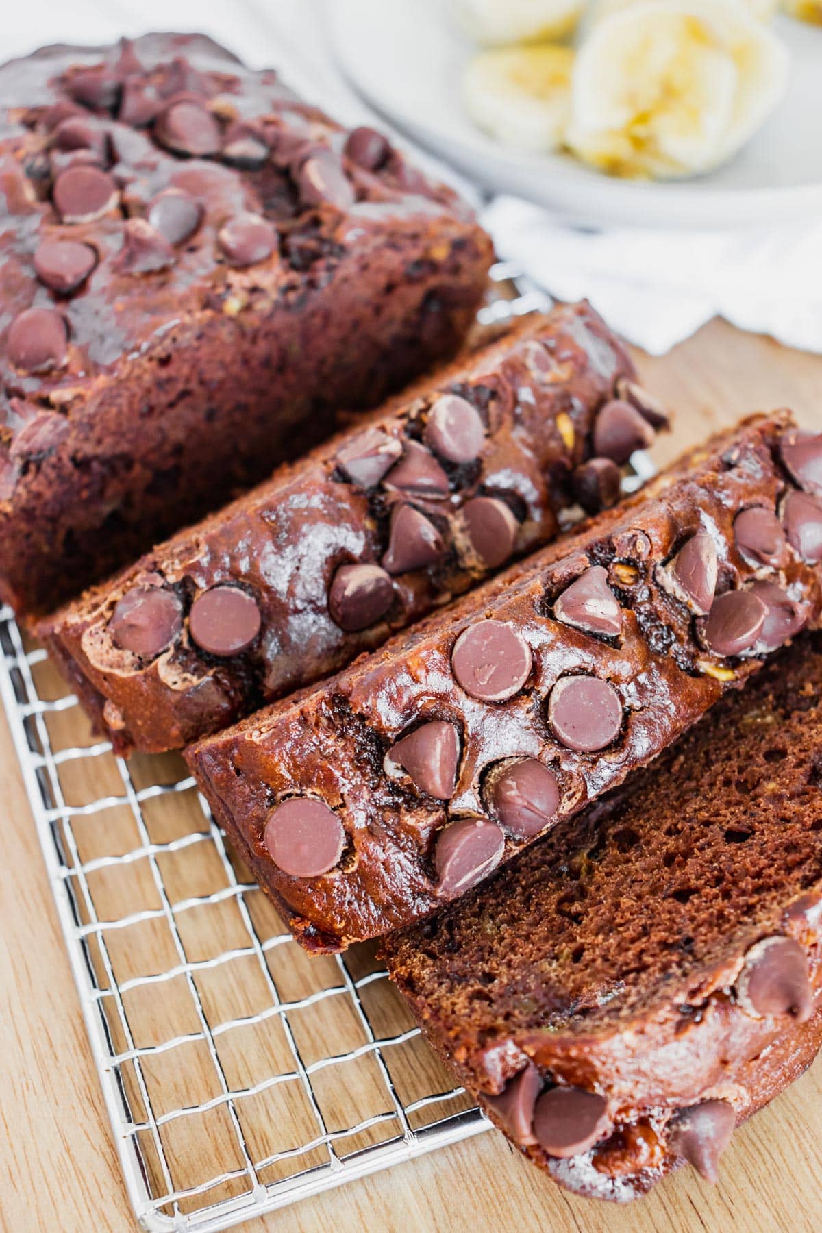 The finished Double Chocolate Banana Bread sliced on a wire rack. 