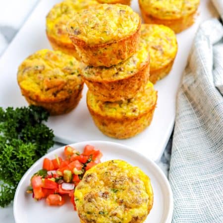 Three of the finished egg muffins stacked on top of each other.