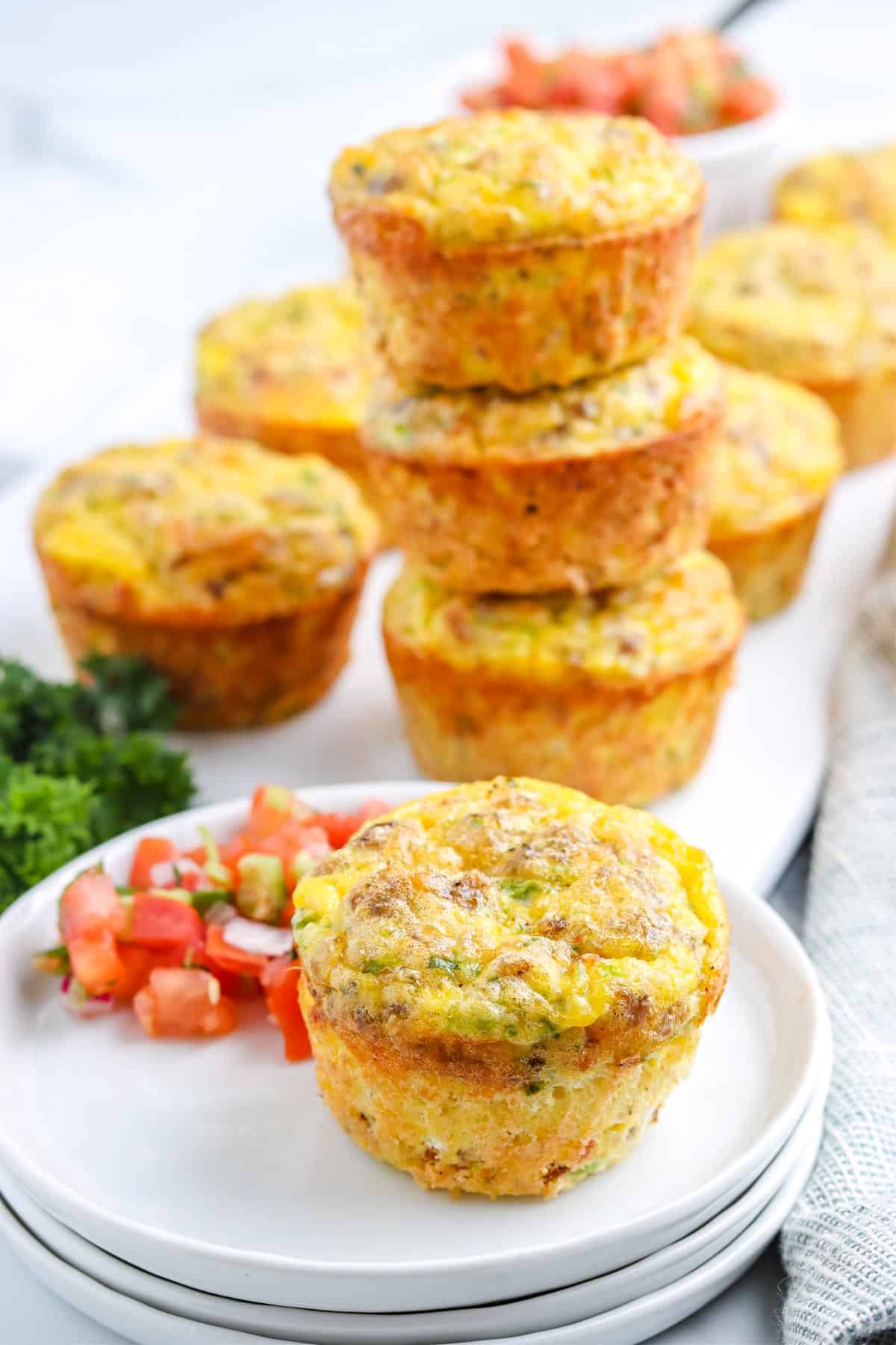 The finished Egg Muffins on a white plate and serving platter. 