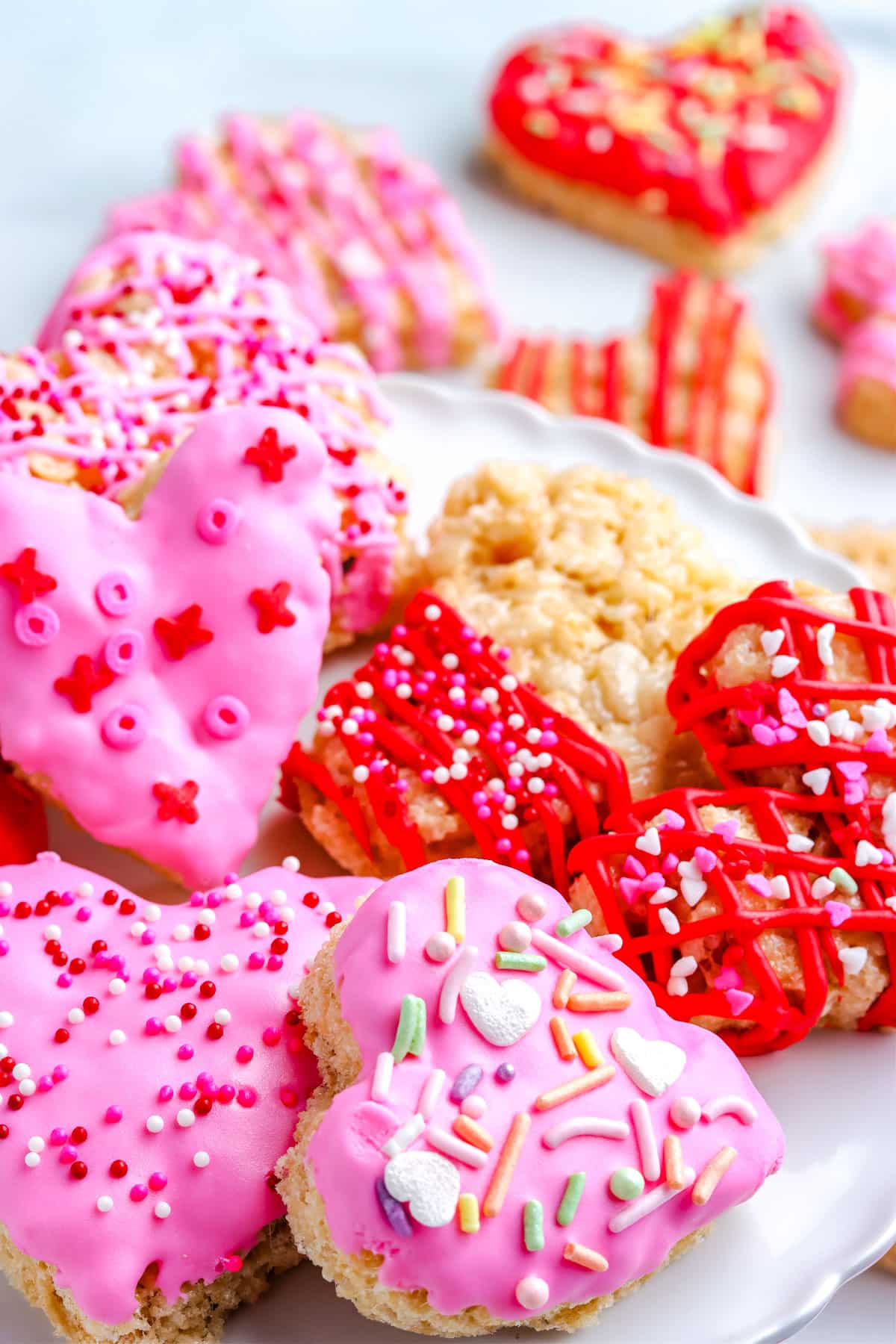 The finished Heart Shaped Rice Krispie Treats piled on a serving platter.