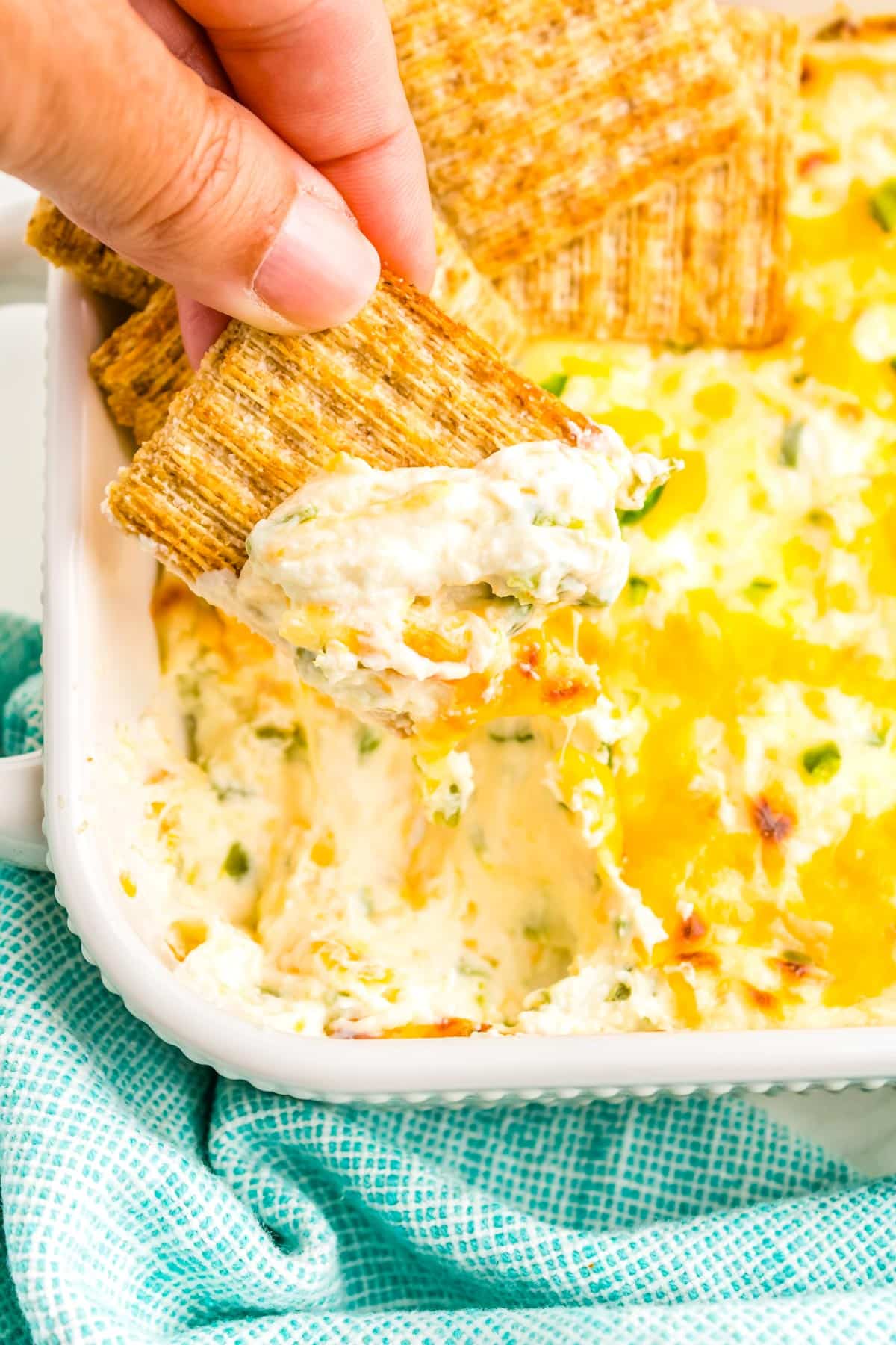 A cracked being dipped into the Jalapeno Dip.