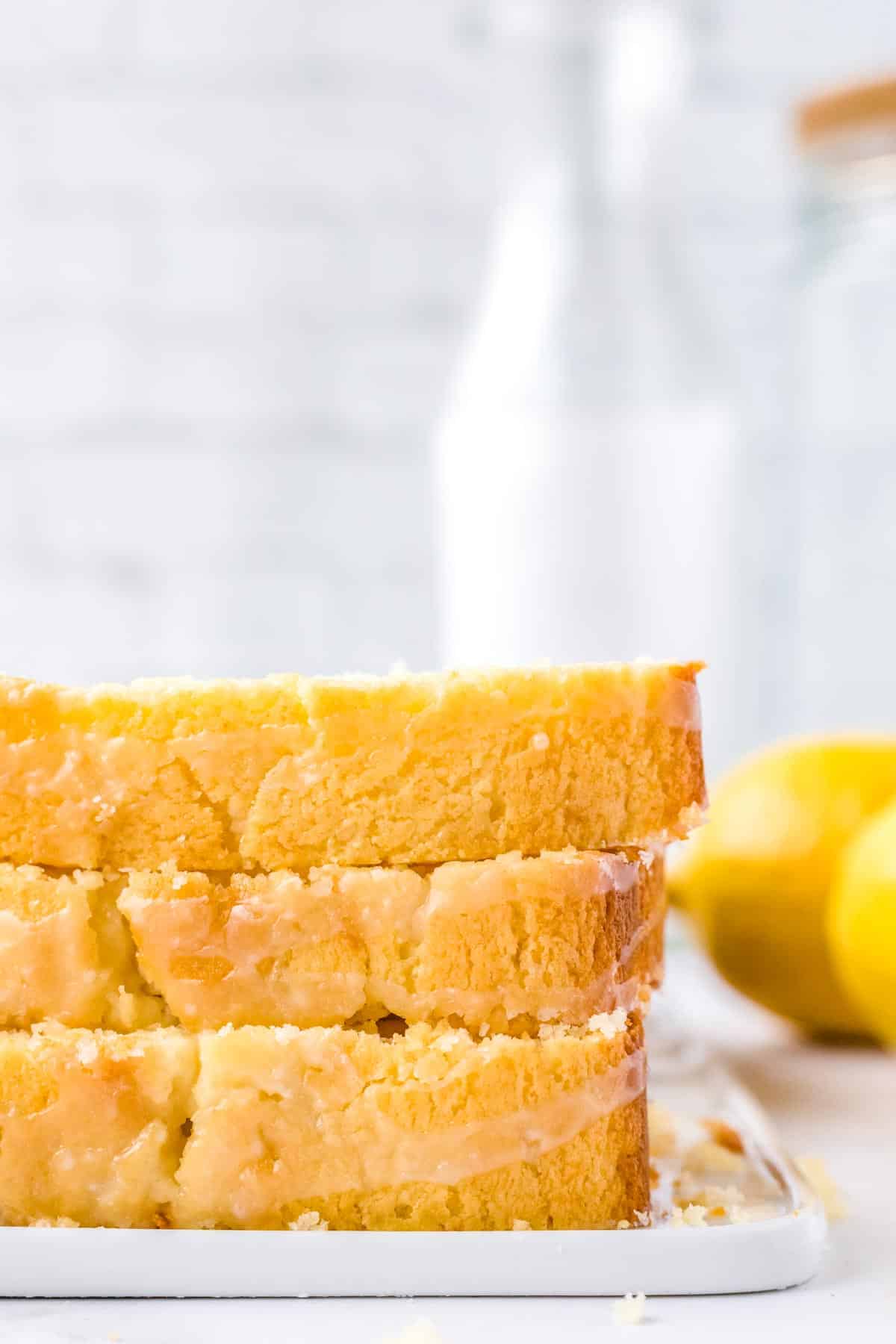 Three slices of the Lemon Bread With Glaze stacked on top of each other.