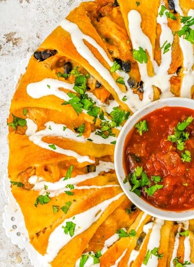 A close up picture of the finished Chicken Enchilada Crescent Roll Wreath on a serving platter.