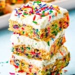 A close up picture of four Funfetti Cookie Bars stacked on top of each other.