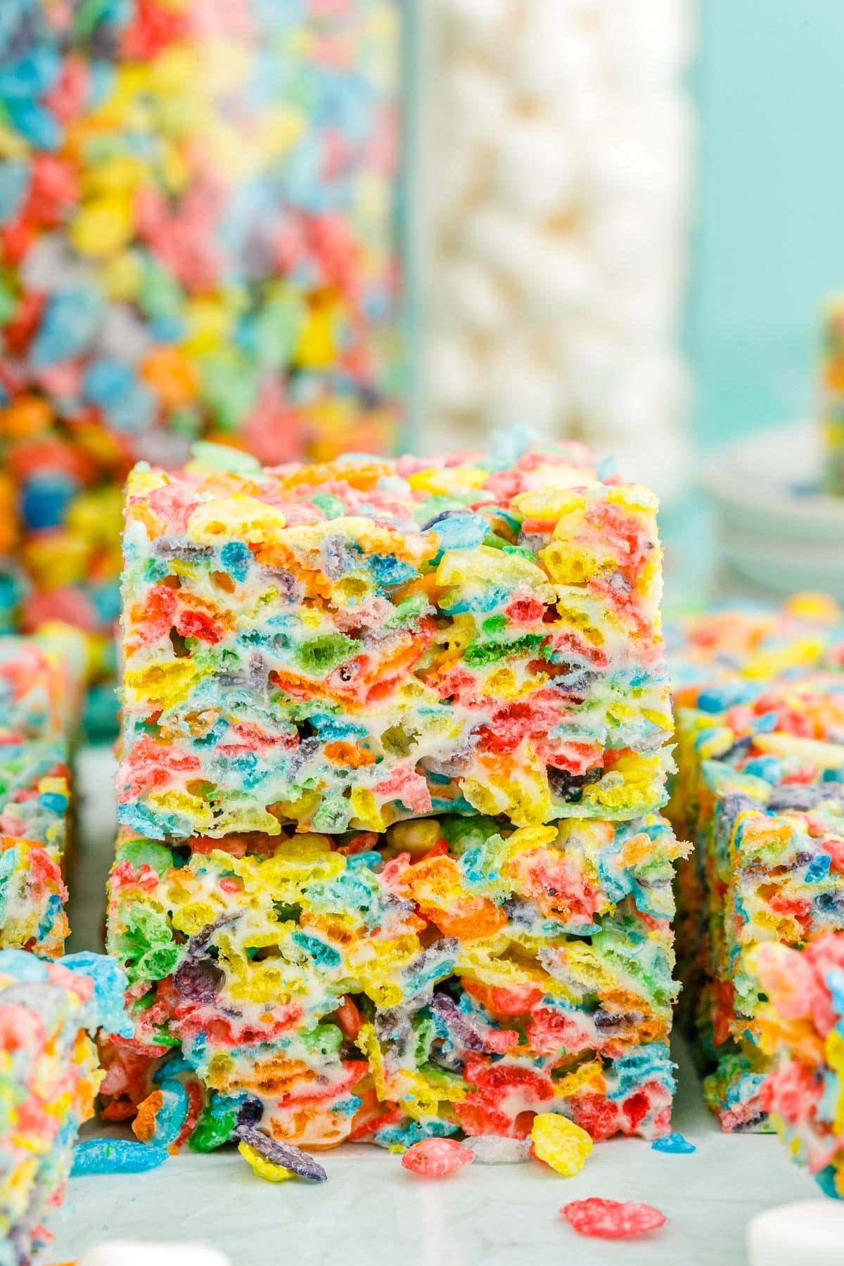 Two Fruity Pebble Rice Crispy Treats stacked on each other.