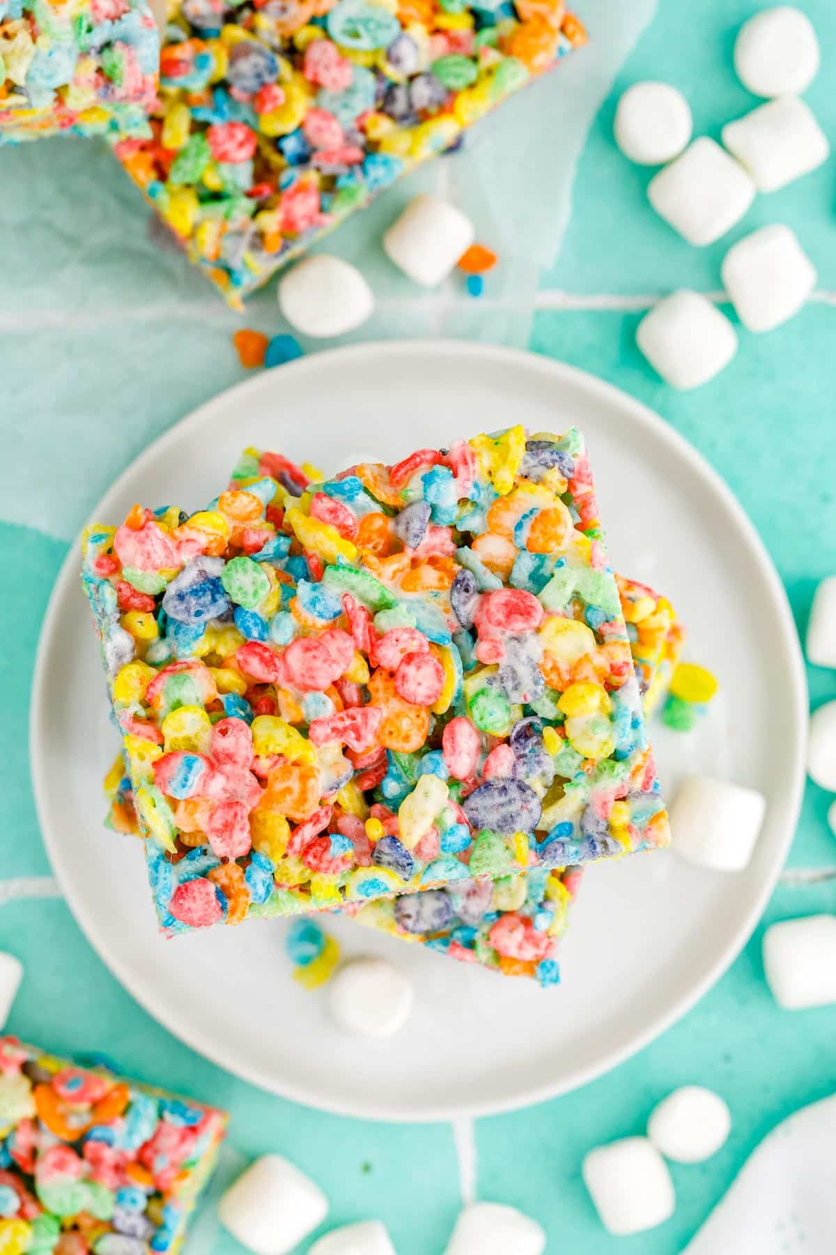 An overhead picture of the finished Fruity Pebbles Rice Crispy Treats on a white plate.