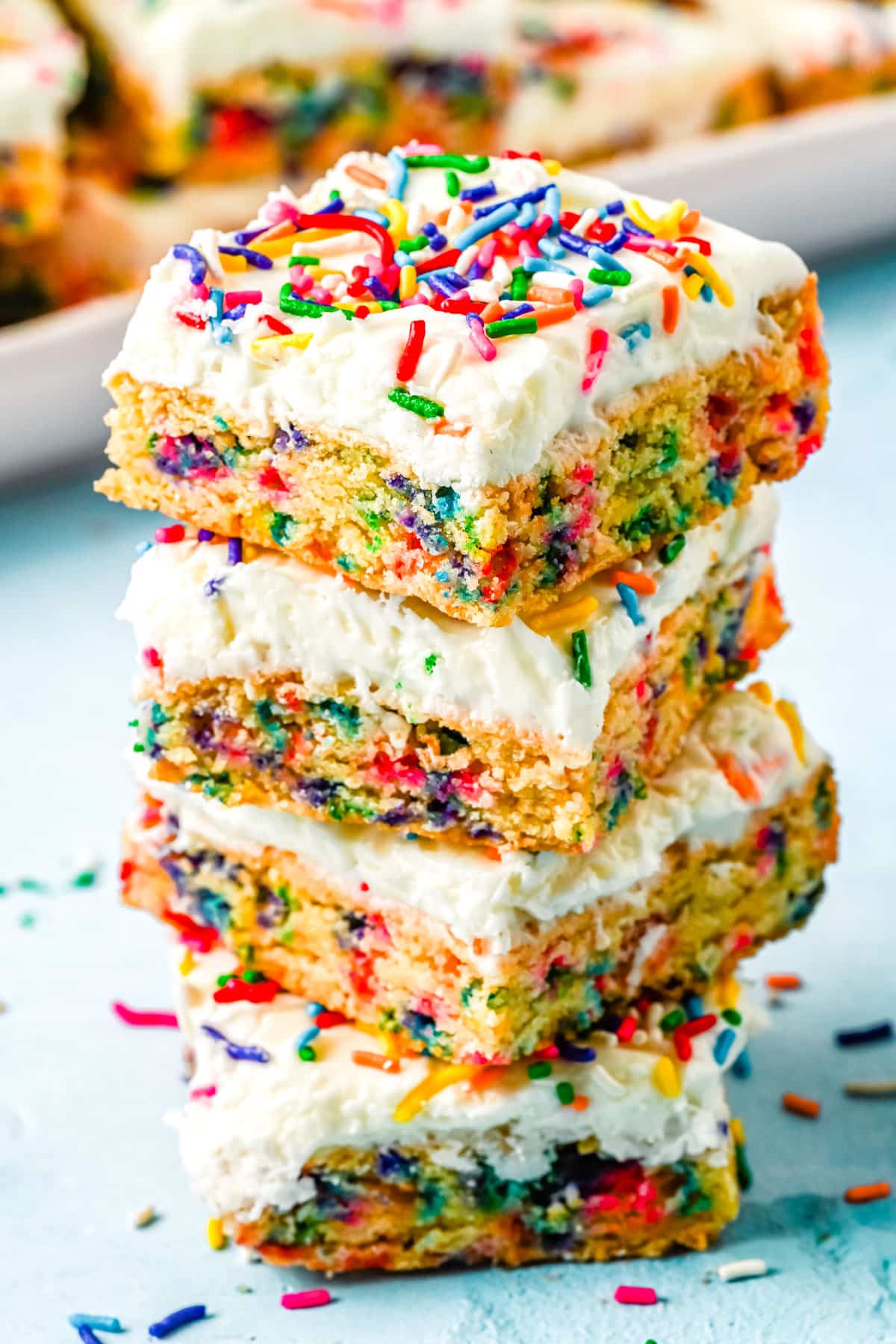 Four Funfetti Cookie Bars stacked on top of each other. 