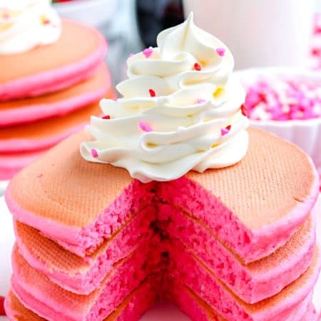 A stack of the Pink Pancakes that have been cut into so you can se what the fluffy interior looks like.