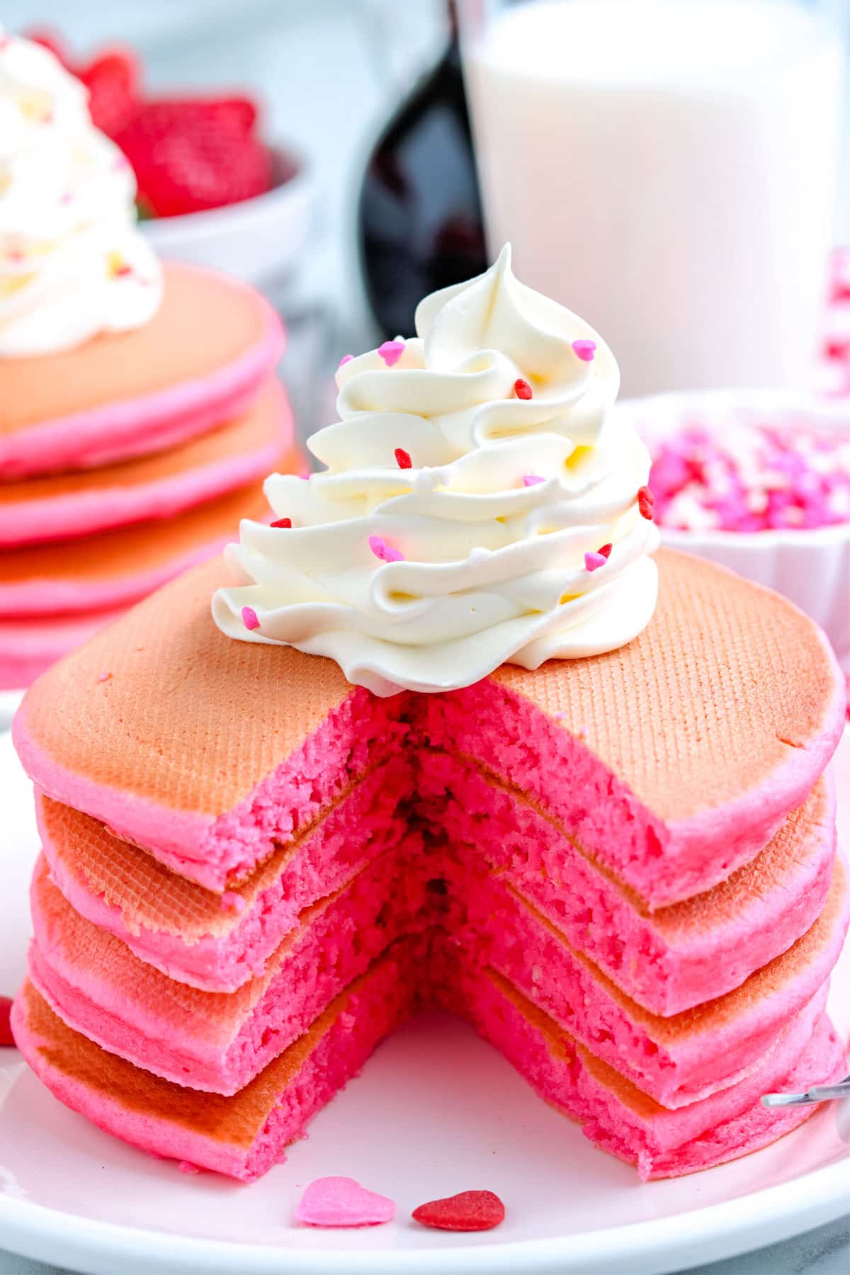 A stack of the Pink Pancakes that have been cut into so you can se what the fluffy interior looks like. 