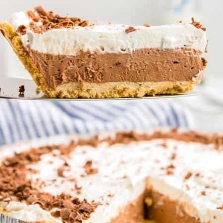 A slice this French Silk Pie recipe taken out of the pie and resting onto of a pie spade.