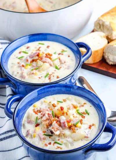 The finished Ham and Corn Chowder in blue serving bowls.