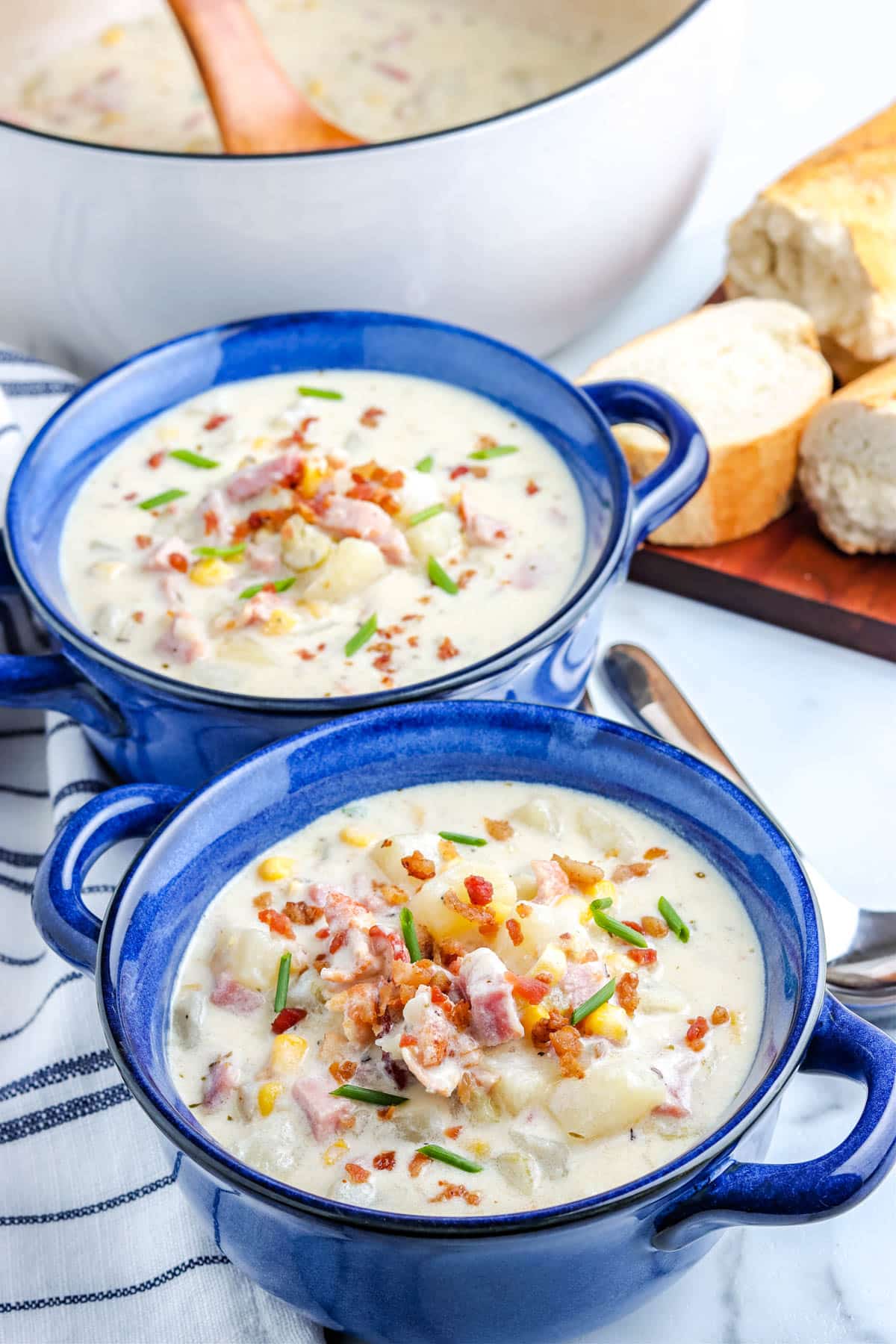 The finished Ham and Corn Chowder in blue serving bowls. 