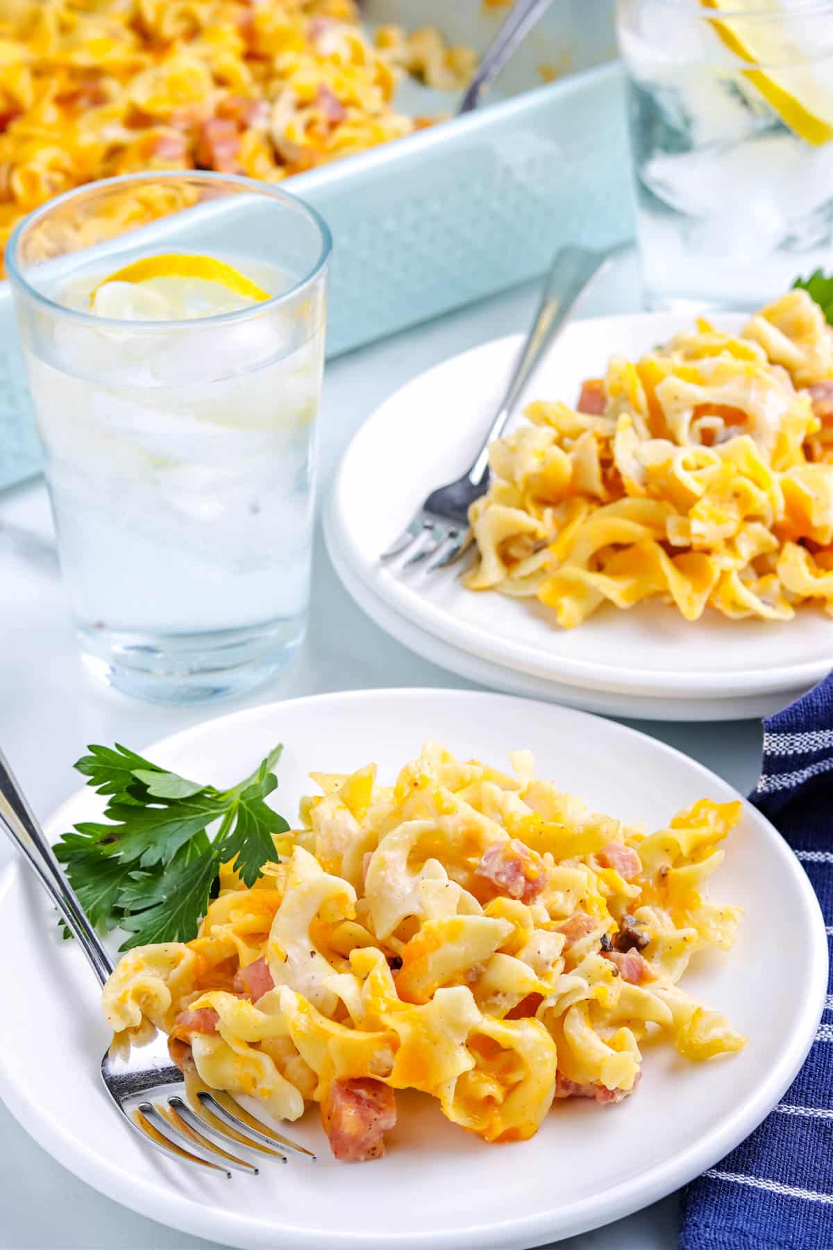 Some of the Ham and Noodles Casserole on white serving plates.
