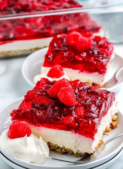 Slices of the finished Raspberry Pretzel Salad on white plates.