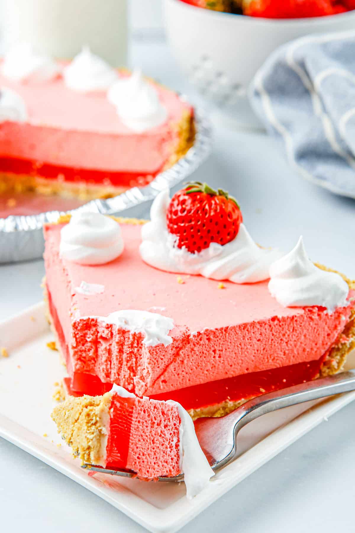 A slice of pie with a forkful taken out of it.