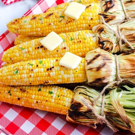 The finished Grilled Corn On The Cob In Husk on a serving platter.