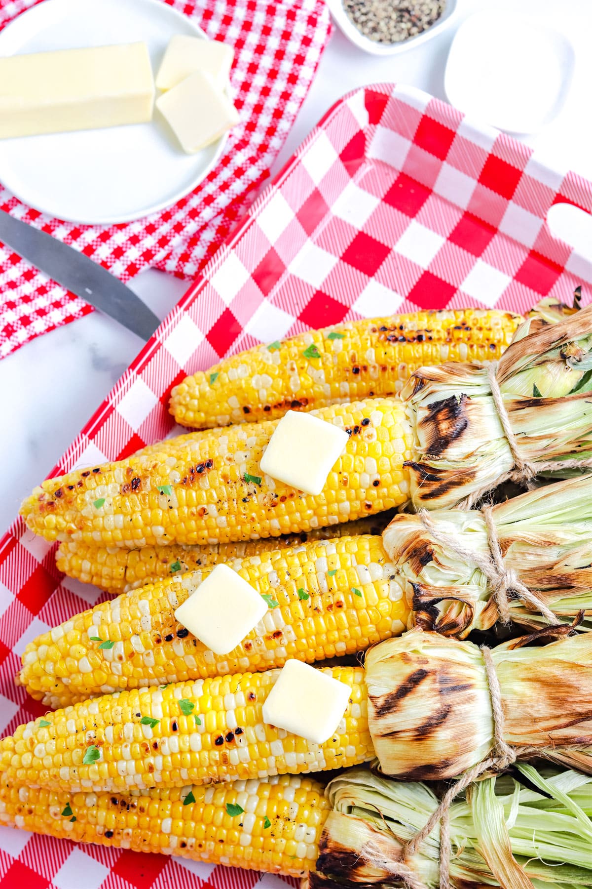 An overhead picture of the finished Grilled Corn On The Cob In Husk recipe. 