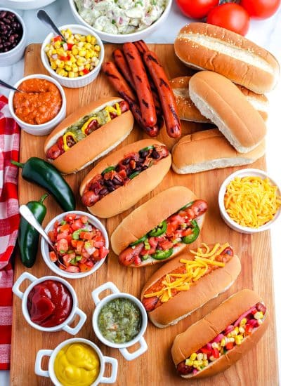 An overhead picture of Grilled Hot Dogs with all of the fixings.
