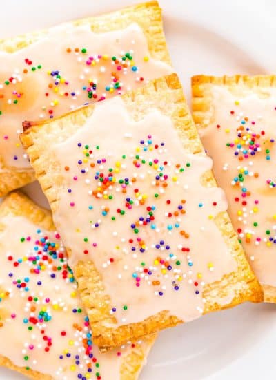 A close up picture of Homemade Strawberry Pop Tarts on a white serving plate.