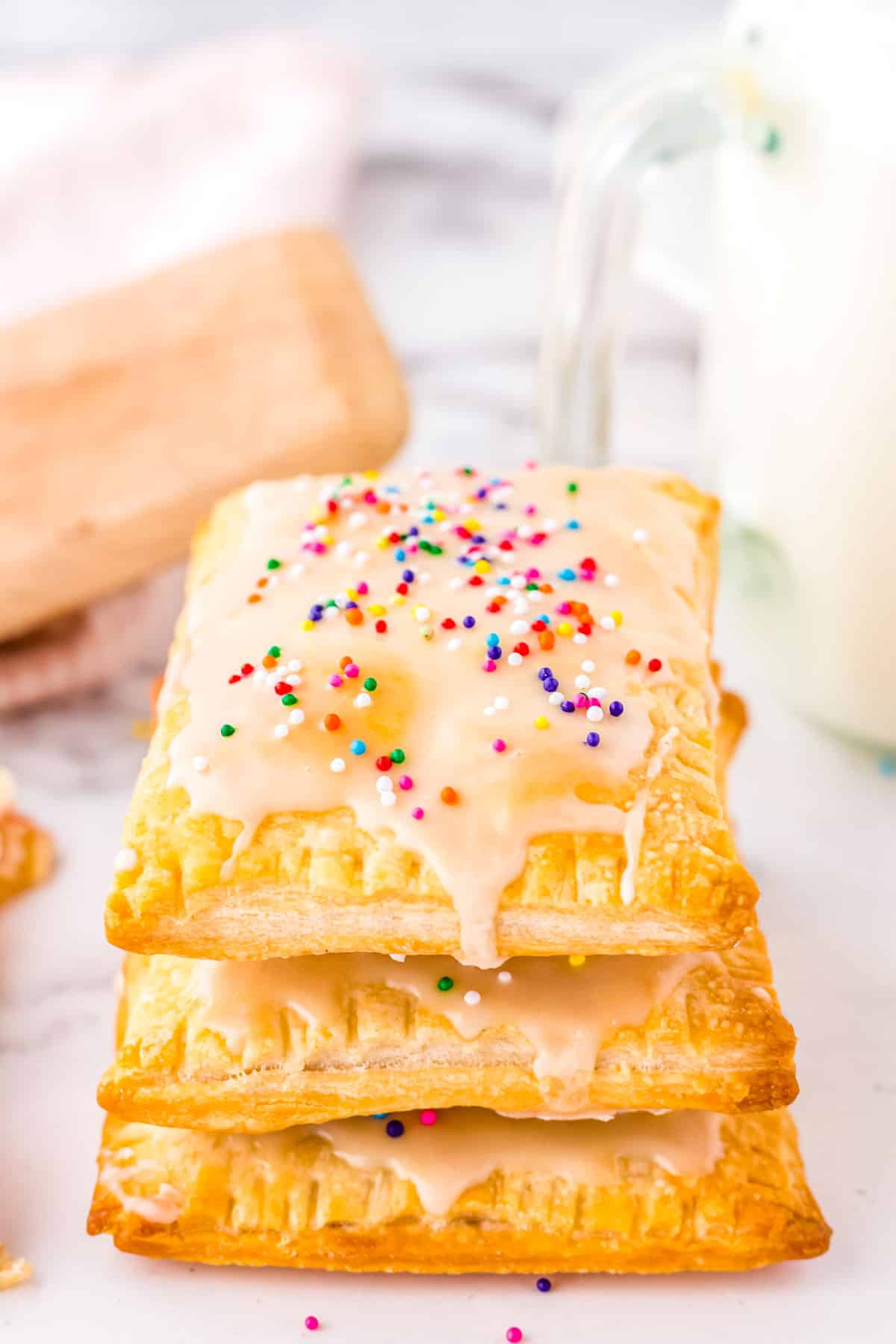 Three Homemade Strawberry Pop Tarts stacked on top of each other.