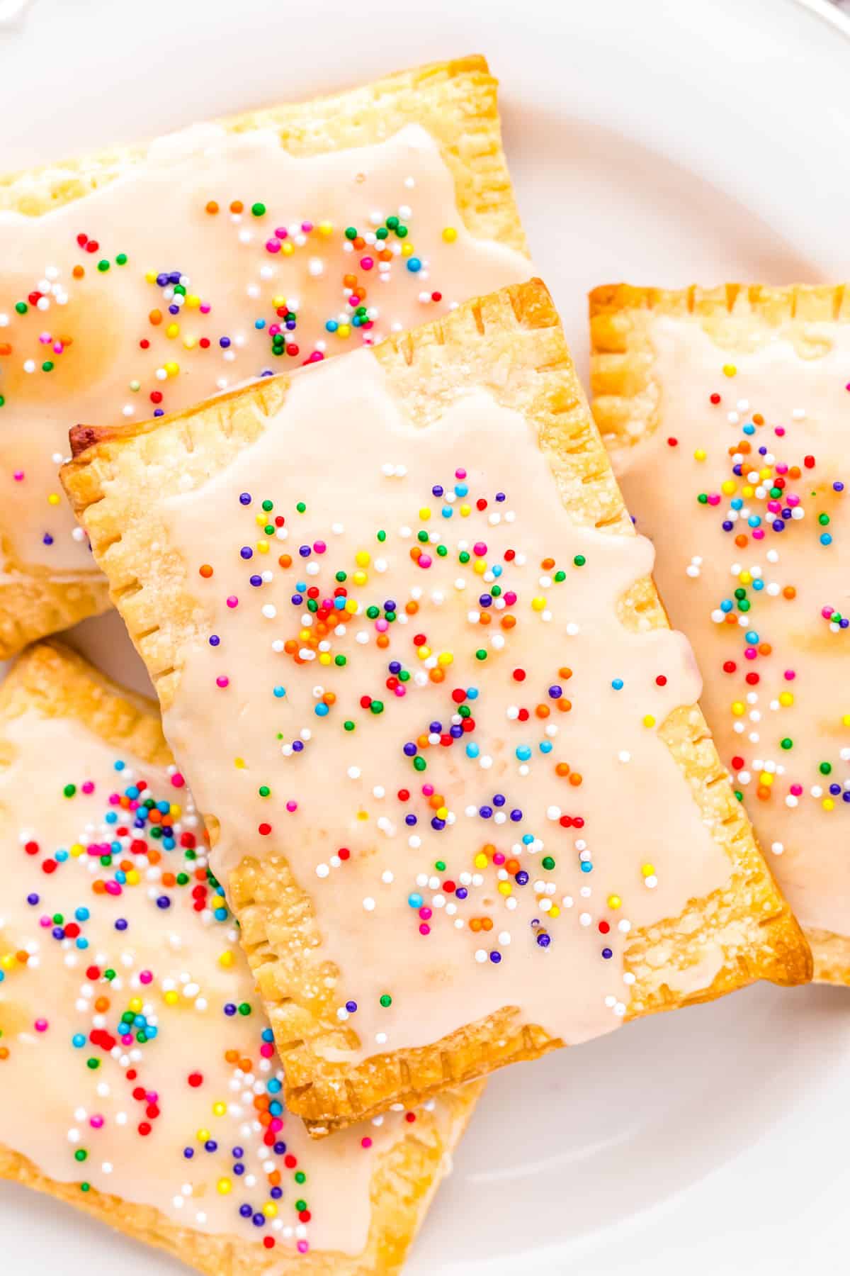 A close up picture of Homemade Strawberry Pop Tarts on a white serving plate. 