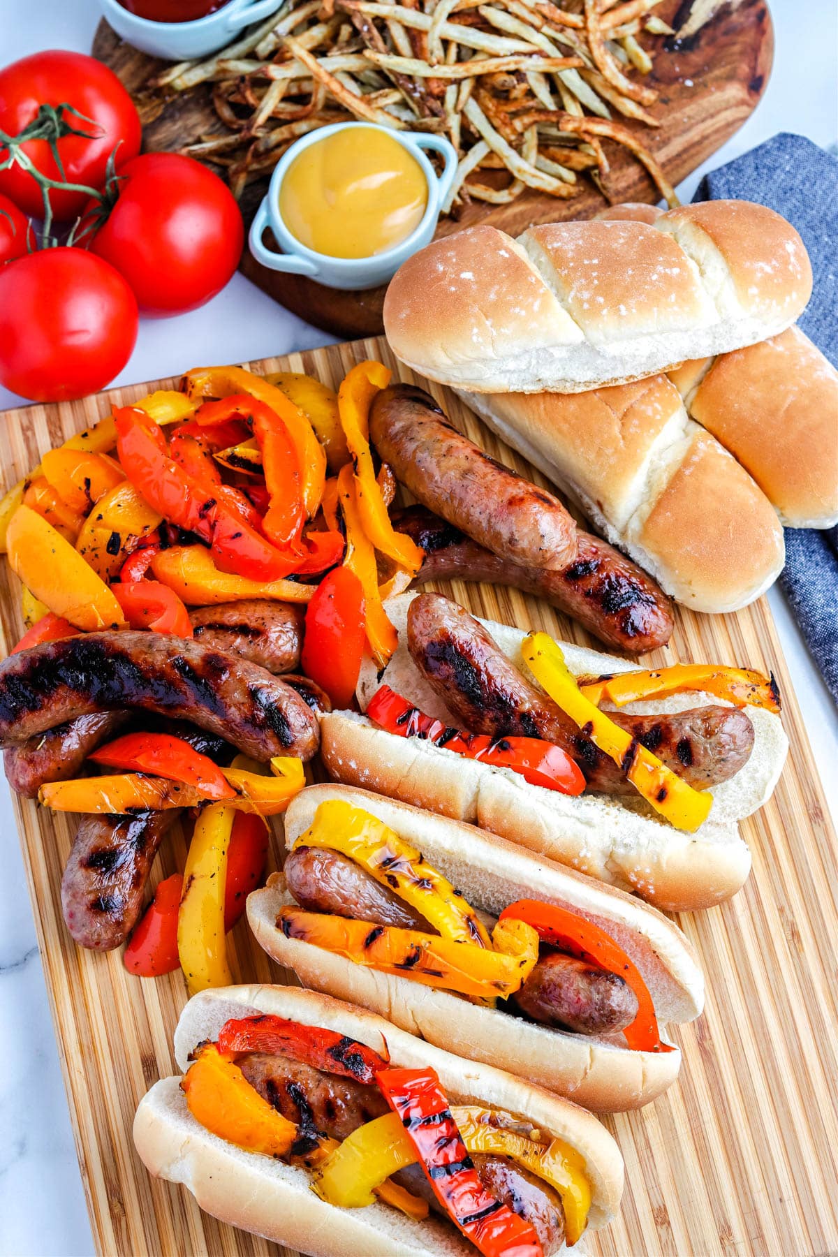The finished Grilled Italian Sausages with bell peppers and rolls.