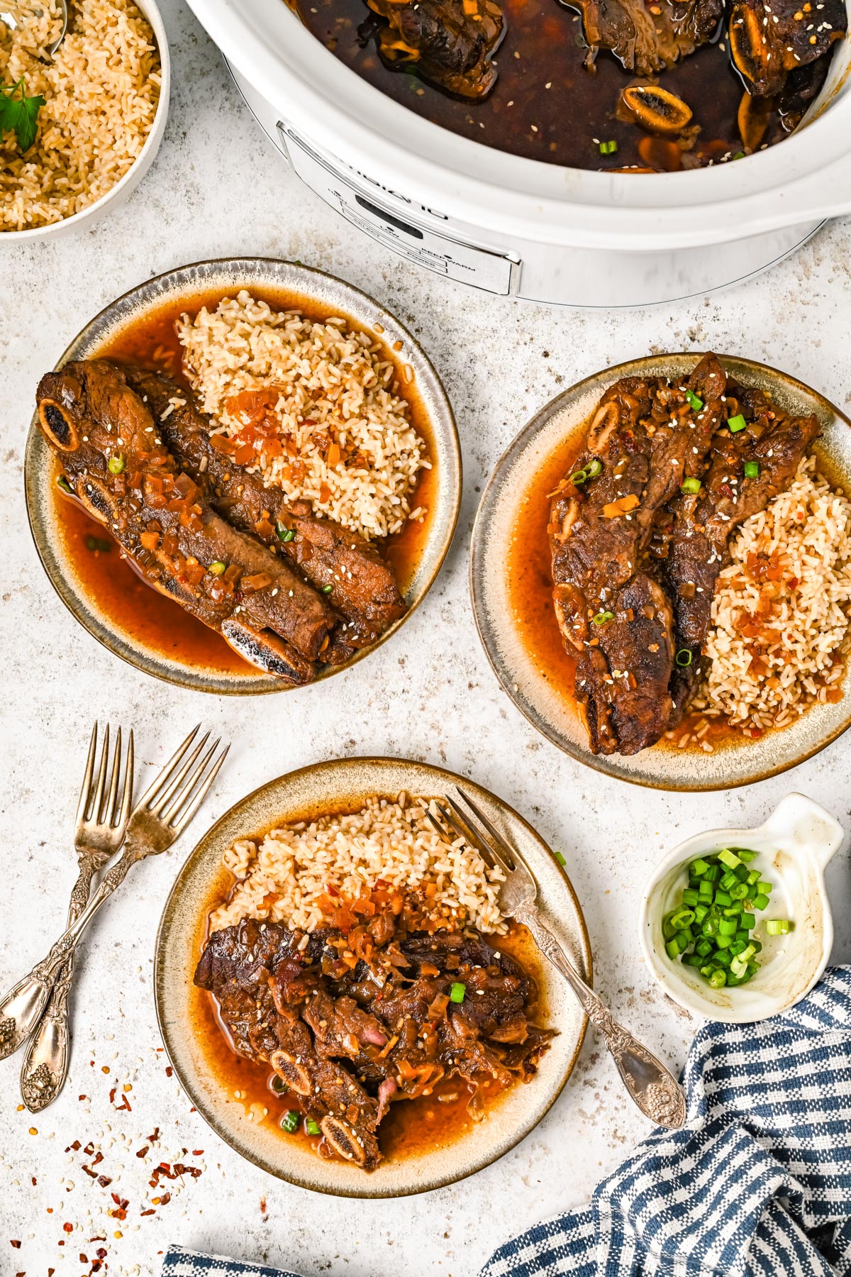 An overhead picture of Korean Short Ribs on plates with rice.