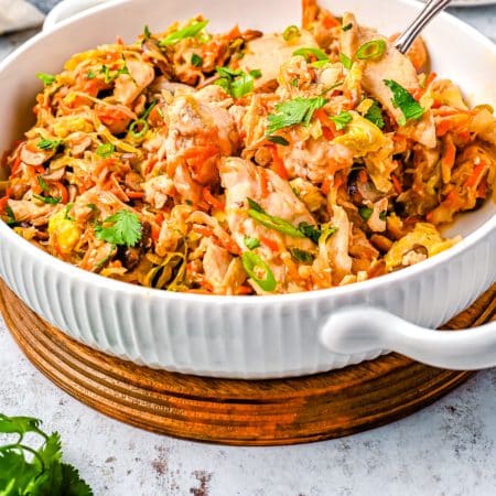 A close up picture of the finished Moo Shu Chicken recipe in a white serving bowl.