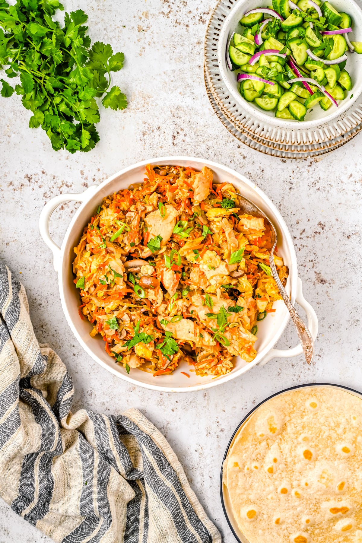 An overhead picture of the finished Moo Shu Chicken along with cilantro and tortillas.