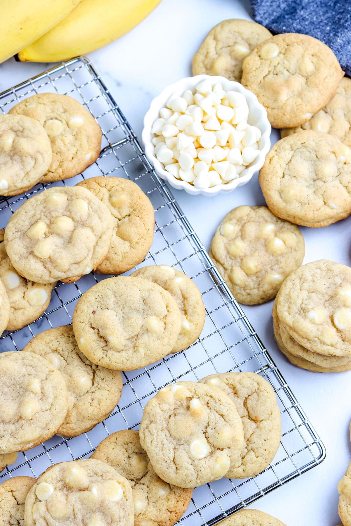 Stacks of banana cookies on a wire rack.