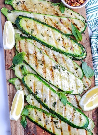 An overhead picture of Grilled Zucchini on a wooden serving board.