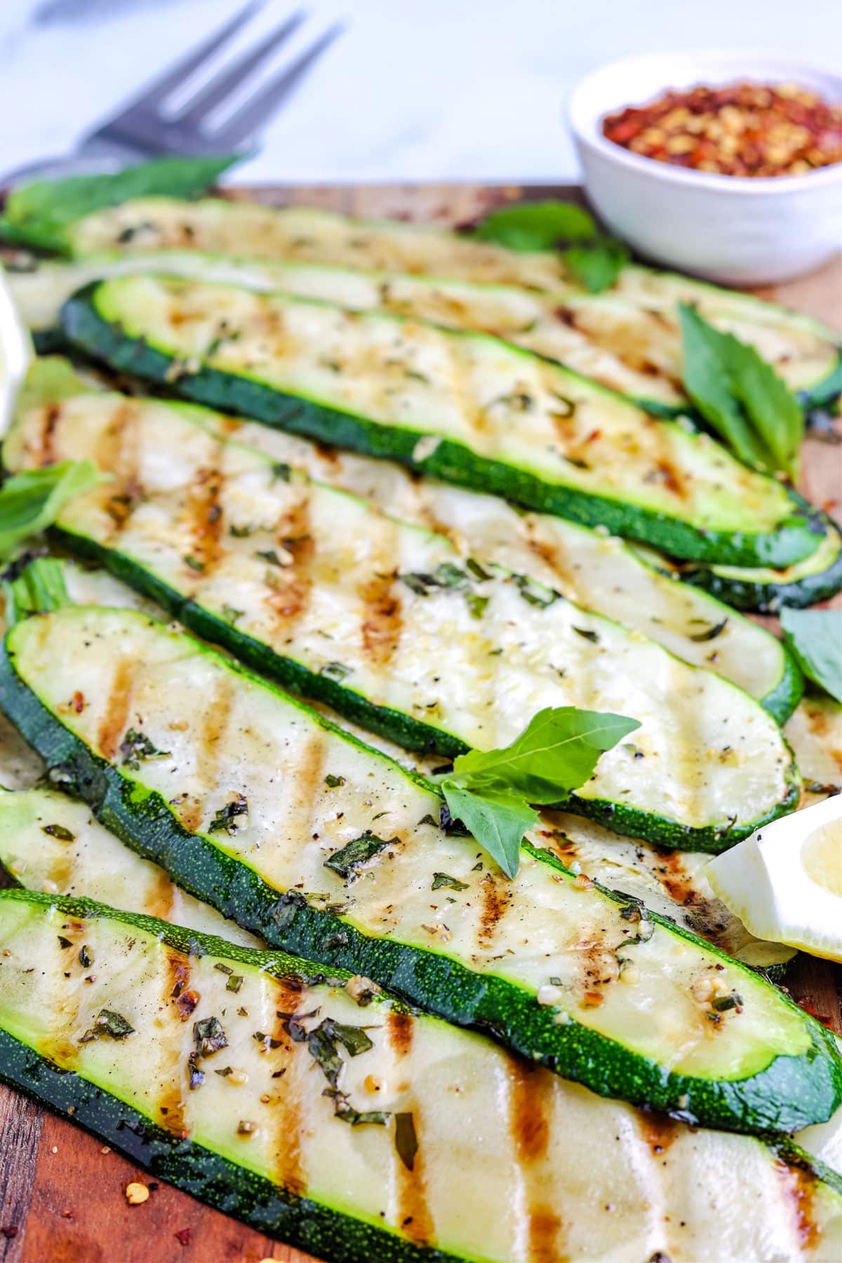 Grilled Zucchini strips on a serving platter.