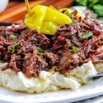 A close up picture of Smoked Mississippi Pot Roast on a plate served with mashed potatoes.