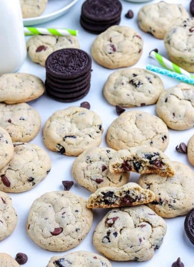 The finished Cookies and Cream Cookies recipe on a counter and one is broken in half.