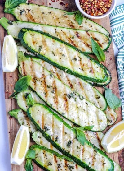 An overhead picture of Grilled Zucchini on a wooden serving board.