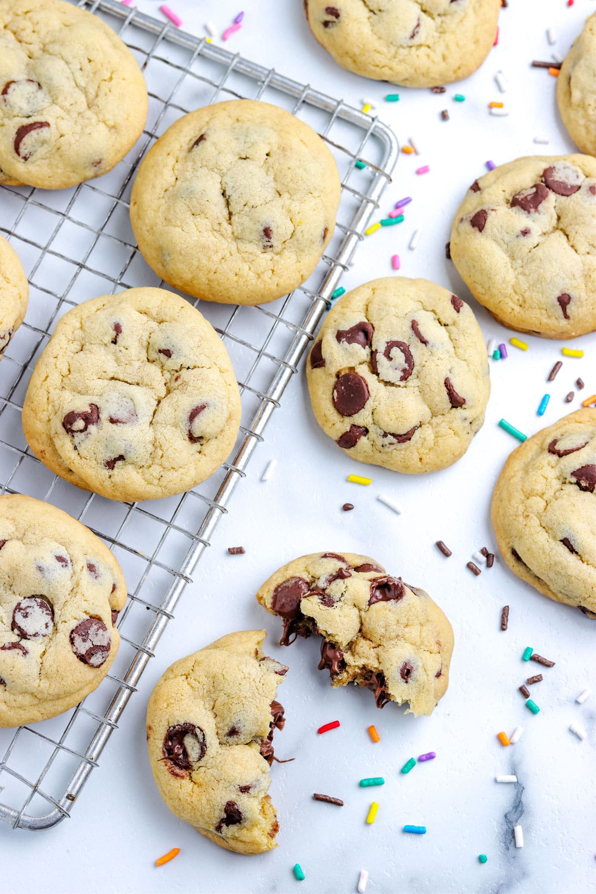 An overhead picture of Chocolate Chip Pudding Cookies on a wire rack and on a countertop.