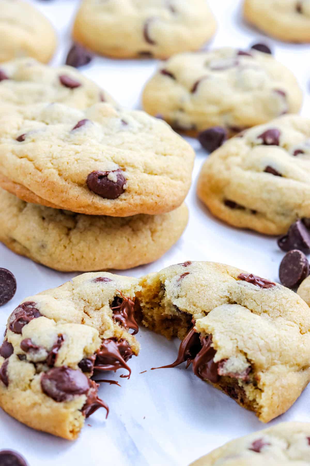 A cookie broken in half so you can see the melted chocolate chips on the inside. 