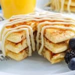 A close up picture of a stack of pancakes that have been cut into.