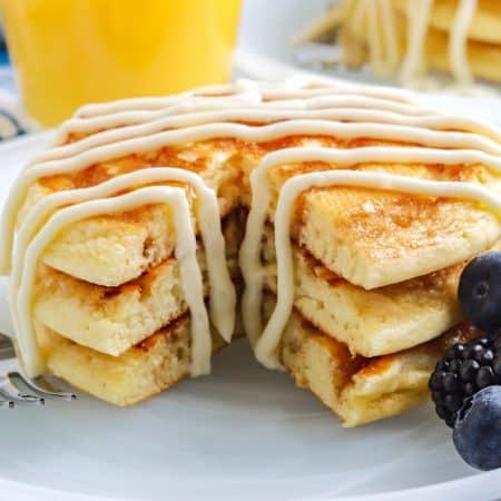 A close up picture of a stack of pancakes that have been cut into.