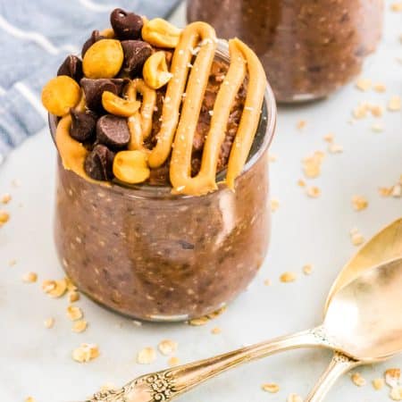 A close up picture of Overnight Oats with peanut butter and chocolate inn a small glass.