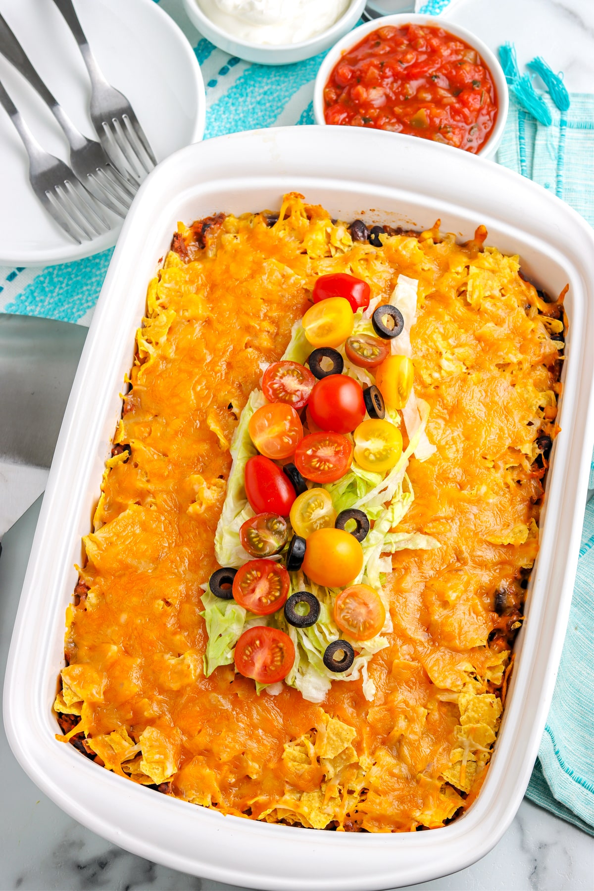 The finished Taco Casserole in a white baking dish. 