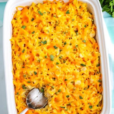 The finished Chicken Noodle Casserole with a serving spoon in it.