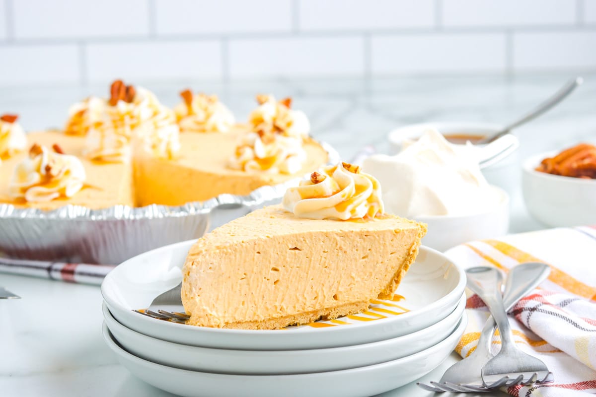 A slice of Cream Cheese No Bake Pumpkin Pie on a white plate.